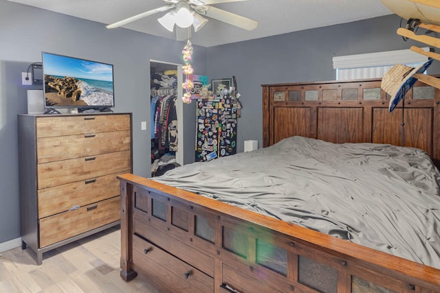 bedroom featuring a closet, light wood-type flooring, and ceiling fan