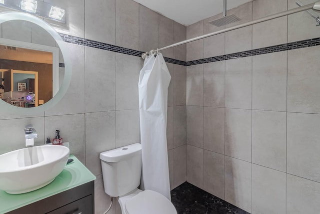 bathroom featuring tile walls, vanity, and a shower with shower curtain