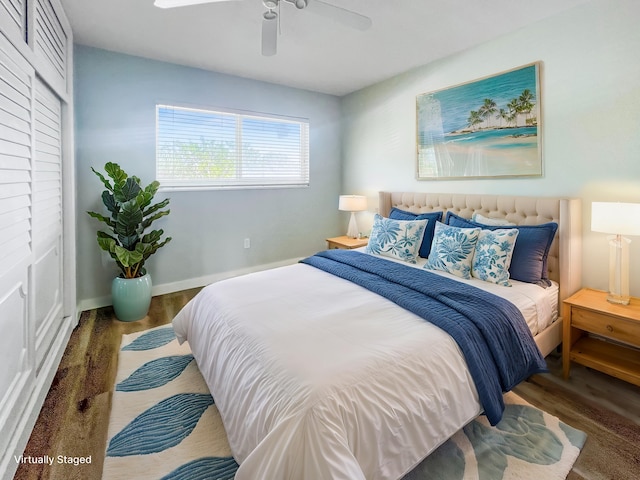 bedroom featuring ceiling fan, baseboards, and wood finished floors