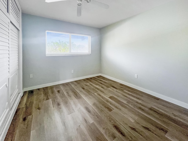 unfurnished bedroom featuring ceiling fan, baseboards, and wood finished floors