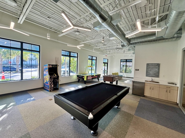 rec room featuring pool table, a healthy amount of sunlight, a sink, and baseboards