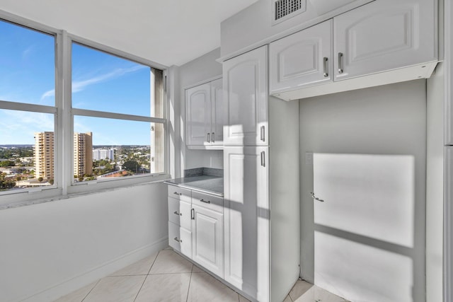 kitchen with white cabinets and light tile patterned floors