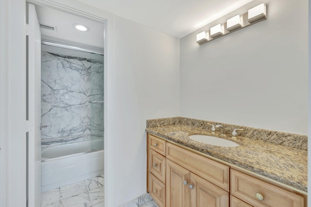 bathroom with combined bath / shower with glass door and vanity