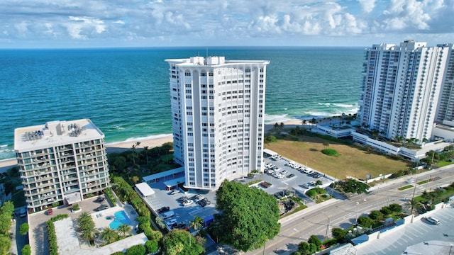 drone / aerial view with a beach view and a water view