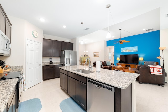 kitchen with dark brown cabinetry, sink, an island with sink, ceiling fan, and appliances with stainless steel finishes