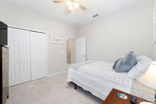 bedroom with a closet, light colored carpet, and ceiling fan