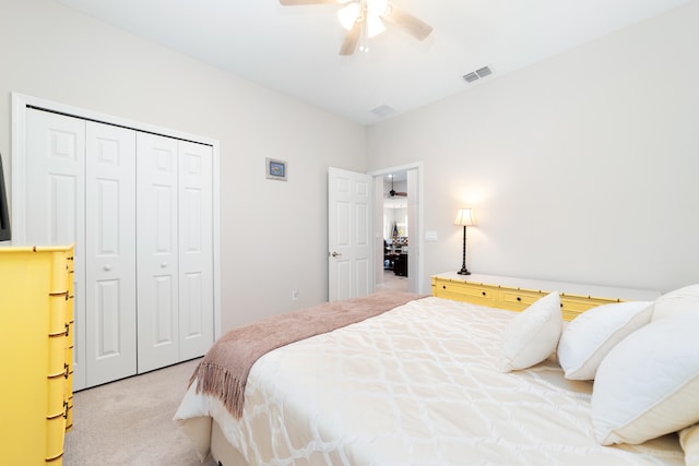 carpeted bedroom featuring ceiling fan and a closet