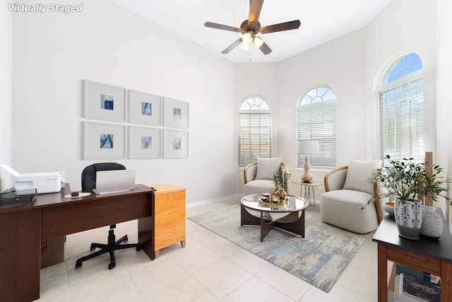 tiled office space with a towering ceiling and ceiling fan