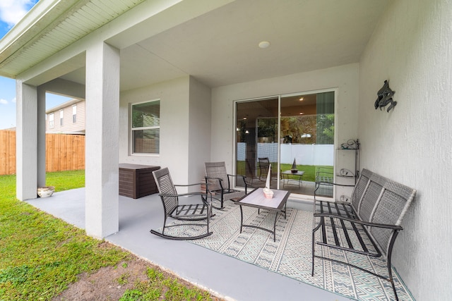 rear view of property with a lawn and a patio area