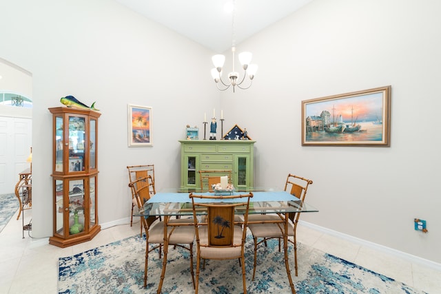 tiled dining space with an inviting chandelier and high vaulted ceiling