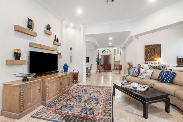 living room featuring decorative columns and crown molding