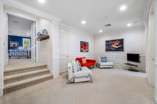 living area with light carpet and ornamental molding