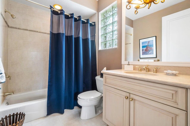 full bathroom with vanity, tile patterned floors, toilet, and shower / tub combo