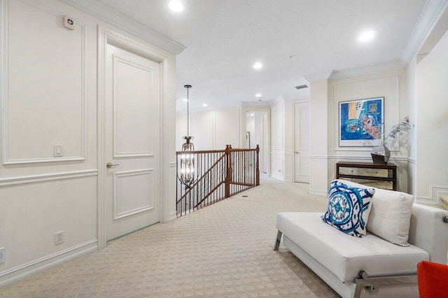 sitting room featuring light colored carpet and crown molding