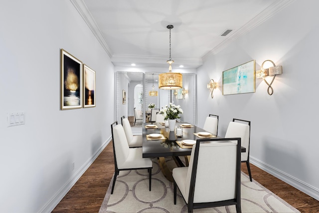 dining area with hardwood / wood-style floors and ornamental molding