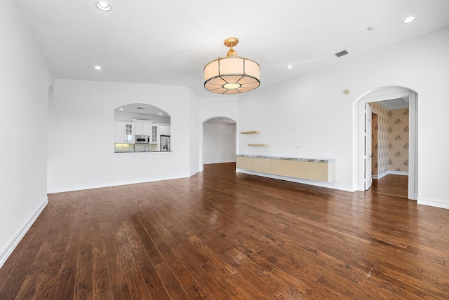 unfurnished living room with dark hardwood / wood-style floors