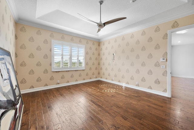 empty room featuring hardwood / wood-style floors, a textured ceiling, ceiling fan, and ornamental molding