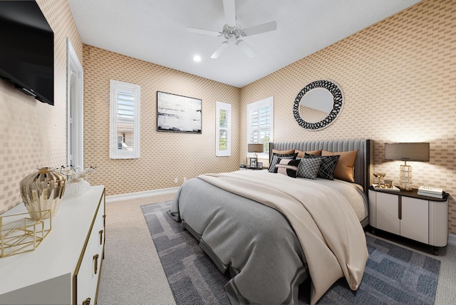 bedroom with ceiling fan and dark carpet