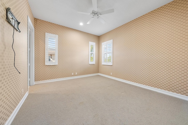 carpeted empty room with ceiling fan