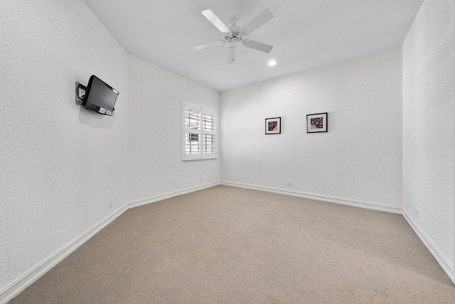 spare room featuring carpet flooring, ceiling fan, and lofted ceiling