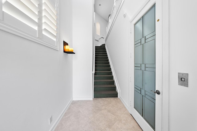 stairs featuring tile patterned flooring