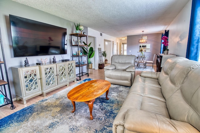 living room with hardwood / wood-style floors and a textured ceiling