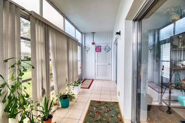 hall featuring light tile patterned floors