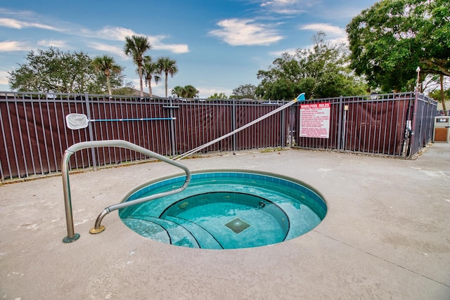 view of pool with a hot tub