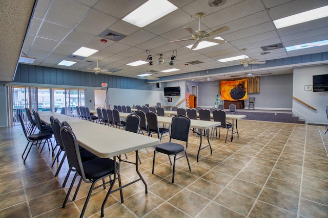 tiled dining area with a drop ceiling