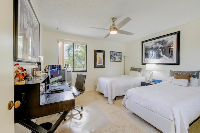 bedroom with light carpet, ceiling fan, and a textured ceiling