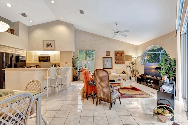 living room with ceiling fan, light tile patterned floors, and high vaulted ceiling