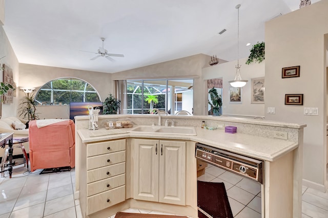 kitchen featuring vaulted ceiling, sink, pendant lighting, light tile patterned floors, and black dishwasher