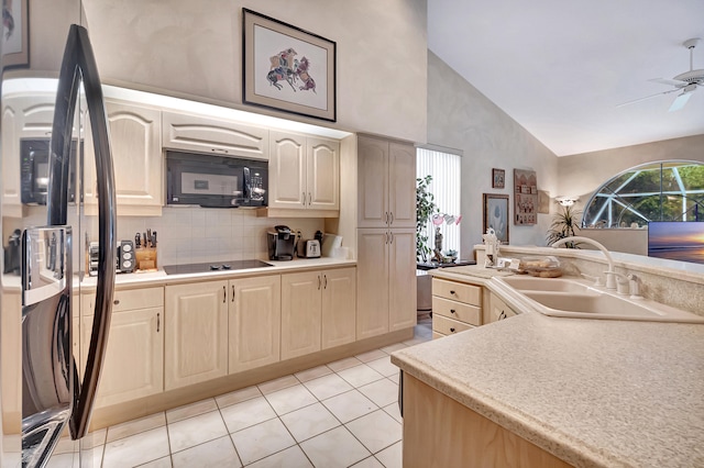 kitchen with ceiling fan, sink, high vaulted ceiling, light tile patterned floors, and black appliances