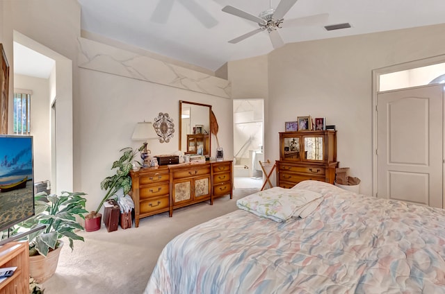 carpeted bedroom with ceiling fan, ensuite bathroom, and vaulted ceiling