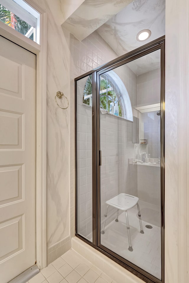 bathroom featuring tile patterned flooring and an enclosed shower