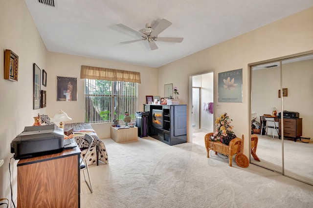 interior space featuring ceiling fan and a closet