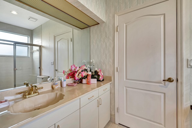 bathroom with vanity, tile patterned floors, and walk in shower