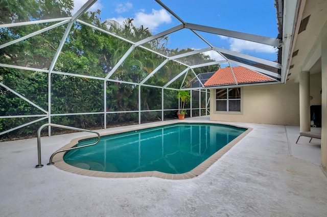 view of pool with a lanai and a patio area