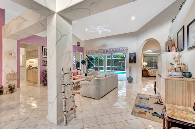 living room featuring ceiling fan, light tile patterned floors, and high vaulted ceiling