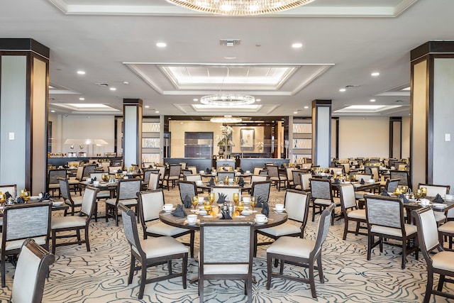 dining area featuring a tray ceiling and an inviting chandelier