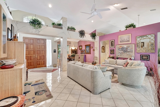 tiled living room featuring a fireplace, ceiling fan, and lofted ceiling