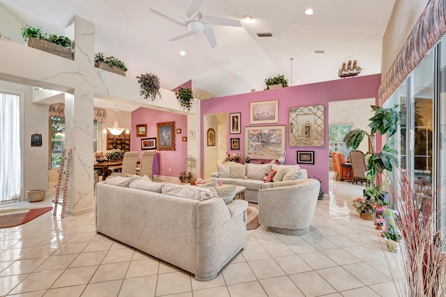 living room featuring ceiling fan with notable chandelier, light tile patterned floors, and high vaulted ceiling