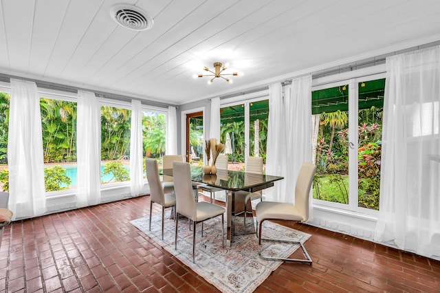 sunroom with an inviting chandelier