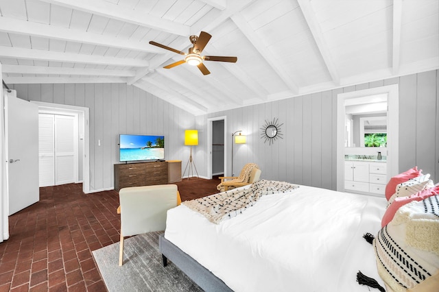 bedroom featuring ensuite bath, wood ceiling, wood walls, ceiling fan, and lofted ceiling with beams