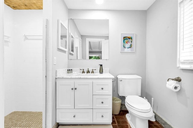 bathroom with vanity, a healthy amount of sunlight, toilet, and a shower