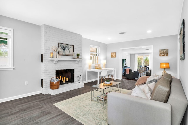 living room featuring dark hardwood / wood-style flooring and a fireplace