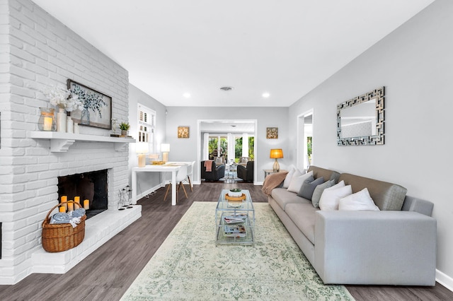 living room with a fireplace and dark hardwood / wood-style flooring