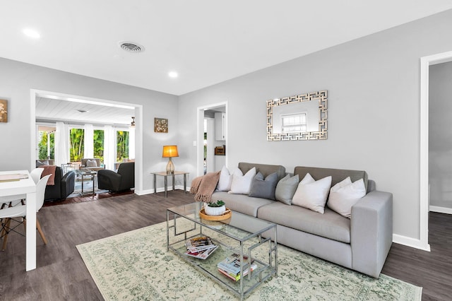 living room featuring dark wood-type flooring