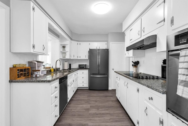 kitchen with stainless steel appliances, dark stone counters, sink, dark hardwood / wood-style floors, and white cabinetry