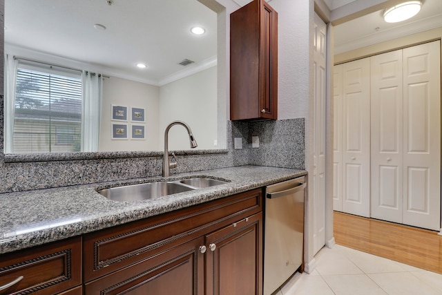 kitchen featuring sink, tasteful backsplash, light tile patterned floors, ornamental molding, and stainless steel dishwasher